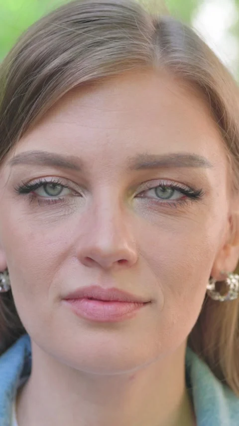 Vertical Video, Close-up, a Serious Young Woman Face Video stock 318015309