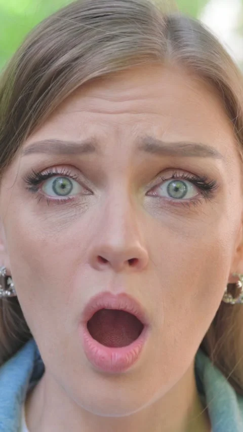 Vertical Video, Close-up, a Shocked Young Woman Face Stock Footage 318015313