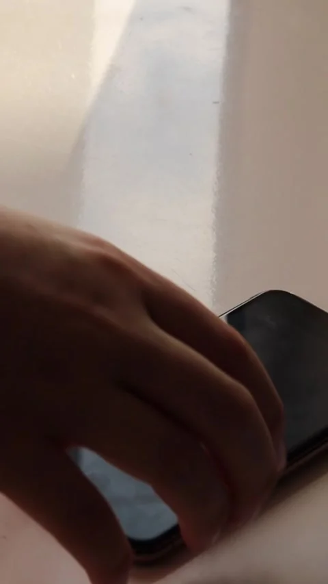 Vertical video. Close-up of a smartphone screen displaying a new email Stock Footage 303850154