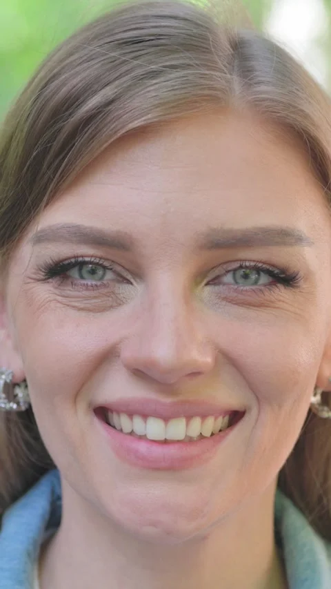 Vertical Video, Close-up, a Smiling Young Woman Face Stock Footage 318015317