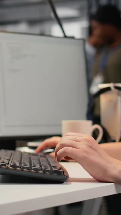 Vertical video Close up of software developer typing on keyboard in office Stock Footage 323404175