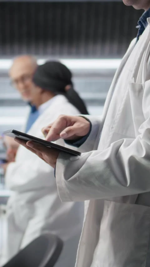 Vertical Video Close up of tablet with modern laboratory software used by Stock Footage 318192827