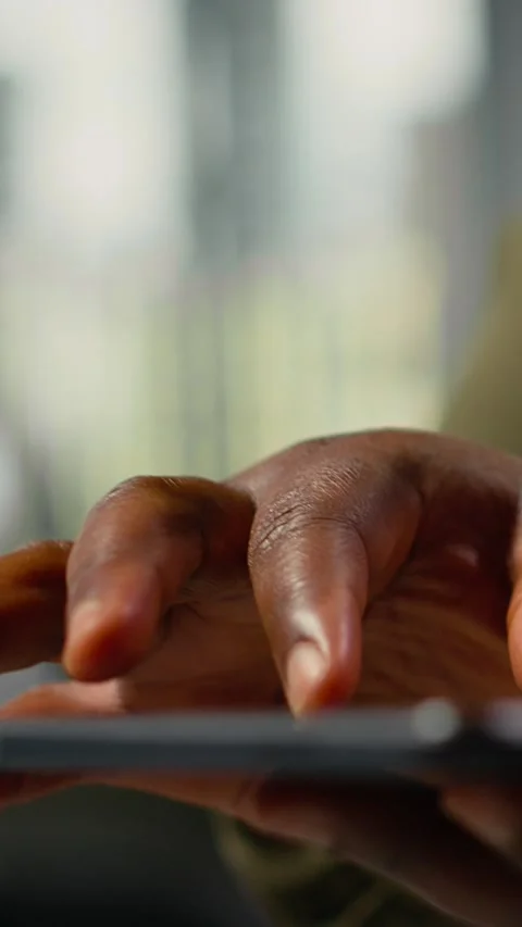 Vertical video Close up of tablet used by programmer in office to accelerate Stock-Footage 323403580