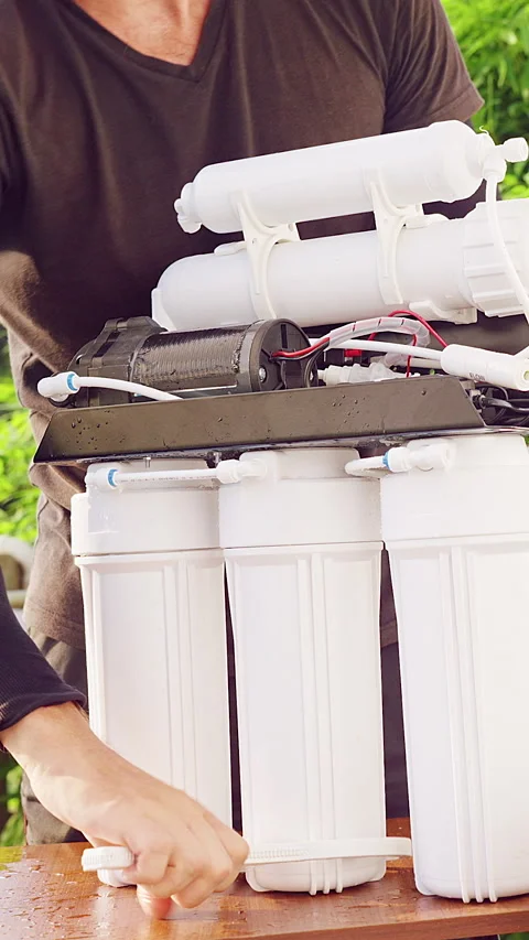 Vertical video. Close Up Tightening Reverse Osmosis Water Filter Housings With P Stock Footage 335214697