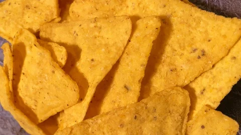 Vertical video. Close up. Triangle nachos corn chips slowly rotating. Unhealthy  스톡 동영상 120609811