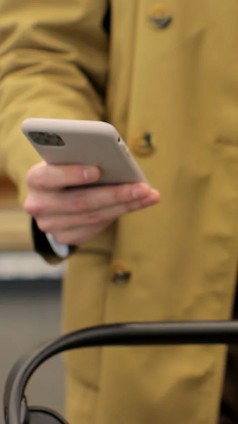 Vertical video. Close up of unrecognizable man using smartphone while carrying 動画素材 346684231