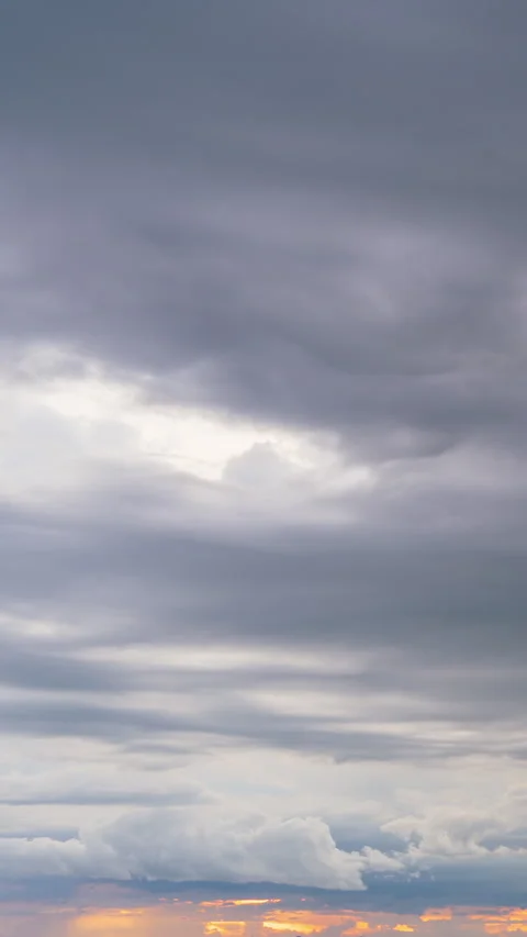 Vertical video. Close View of Colorful Clouds Illuminated by Orange Light of Stock Footage 319279239