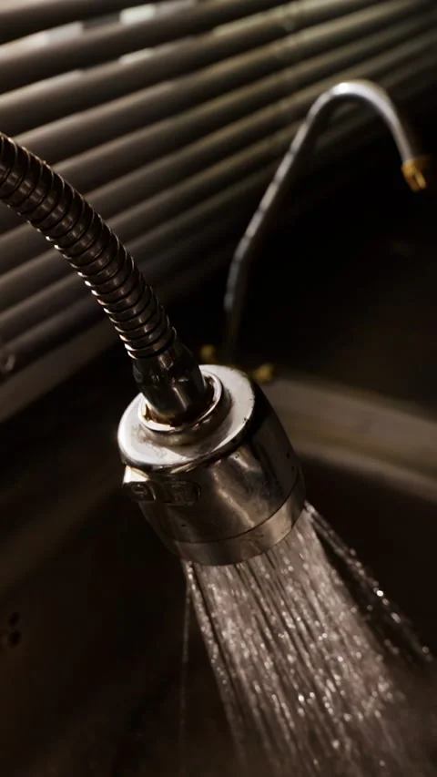 Vertical video. Close View of Flexible Kitchen Faucet Pouring Water into Metal S Stock Footage 340231865
