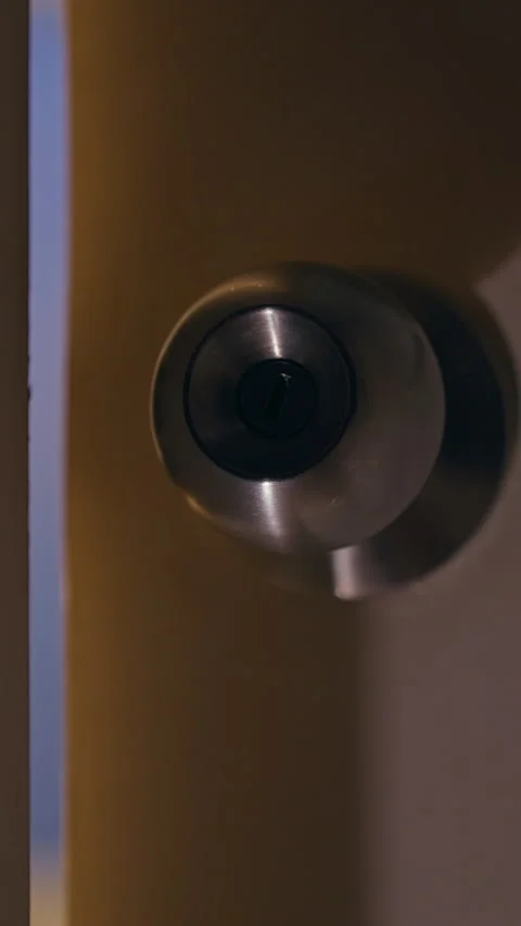 Vertical video. Close Up View of Interior Door Slowly Opening to Narrow Gap Befo Stock Footage 339189059