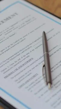 Vertical video Close-up view of a lease agreement document with key, and a .. Fotos Stock