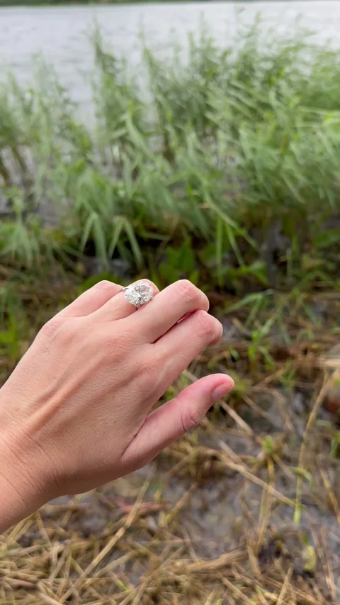 Vertical video close view of oval diamond engagement ring outdoors Stock Footage 317733021