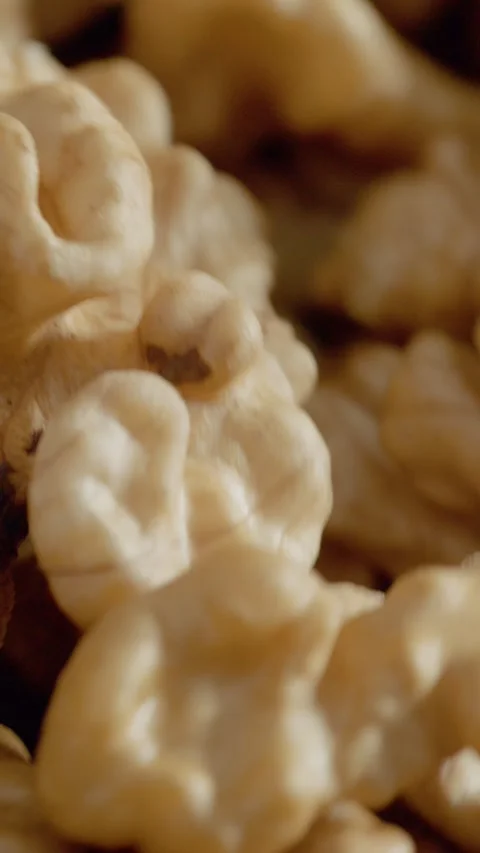 Vertical video Close-up of walnut kernel revealing its detailed texture and Stock Footage 329617905