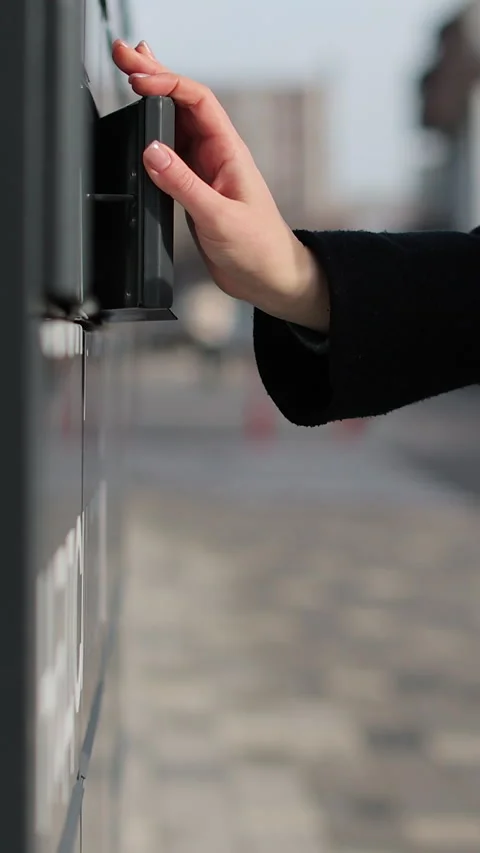 Vertical video Close up woman using self service post terminal machine Stock Footage 339576480