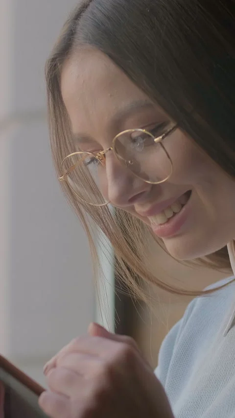Vertical video. Close up woman using app on smartphone in cafe. Stock Footage 340984701
