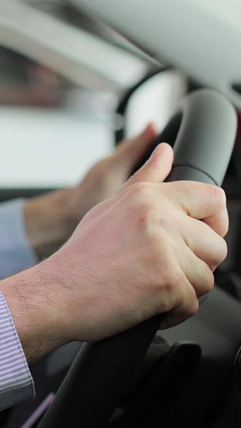 Vertical video Close up young man auto driver car owner holding steering wheel Stock Footage 337236259