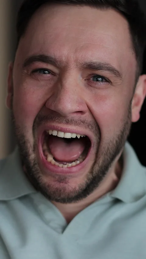 Vertical video Close up of a young stressed man shouting Stock Footage 337650862