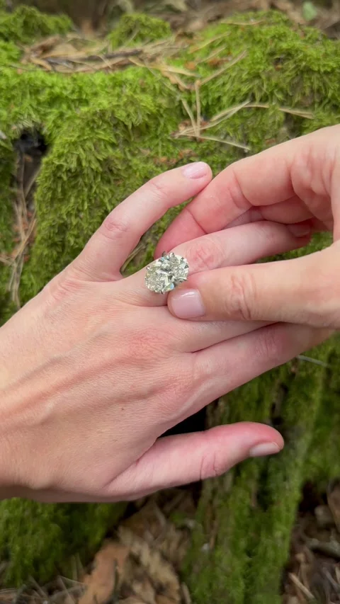 Vertical video closeup of platinum wedding band with oval diamond Stock Footage 317335582