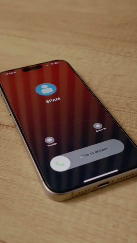 Vertical video Closeup of smartphone receiving spam call on wooden table Stock Footage 346716201