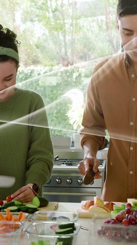 Vertical video: Closeup starting pullback pair chopping food with knife, packing Stock Footage 333289743
