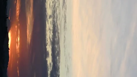 Vertical video of Clouds moving in fast motion with a warm sunset Stock Footage 231569869