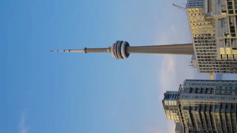 Vertical video of CN Tower and skyscrapers at sunset. Dynamic urban video of Stock Footage 248000455