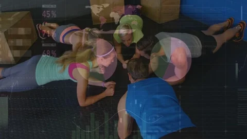 Vertical video: Coach cueing group holding plank circle, facing while charts Stock Footage 332591887