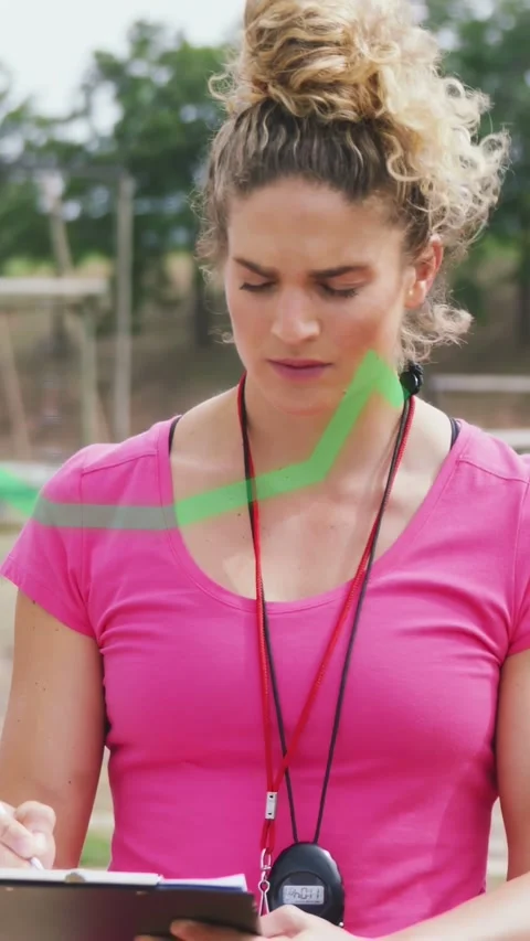 Vertical video: Coach finishing notes lifting head, assessing training, green Stock Footage 332747988