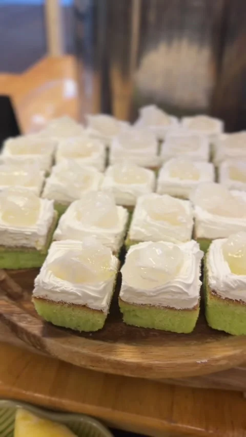 Vertical video of coconut cake squares topped with cream and jelly Stock Footage 321182403