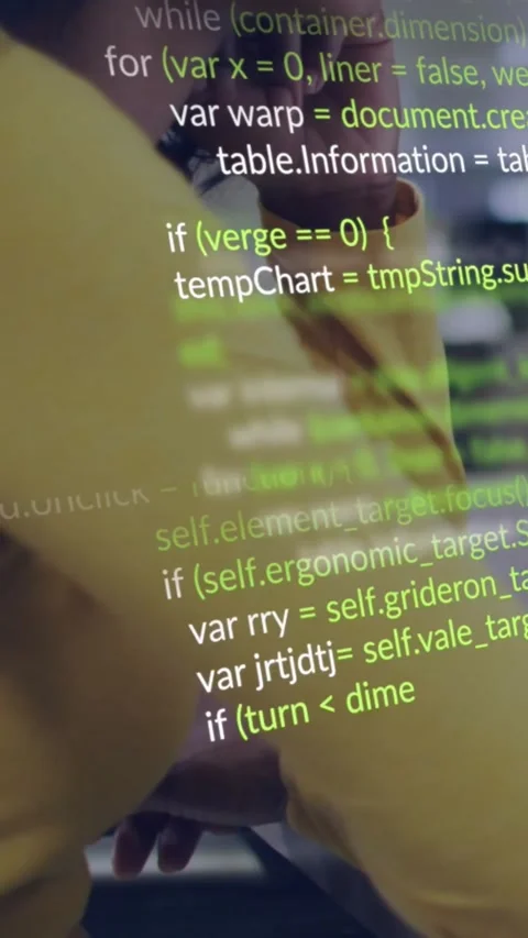 Vertical video: Coder leaning on desk watching screen, screen showing code Stock Footage 330769674