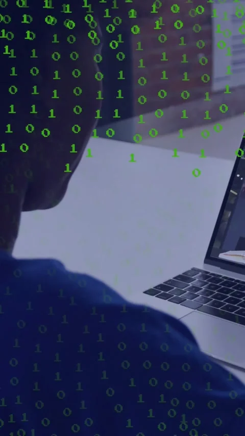 Vertical video: Coder sitting at desk using laptop initiating green 0s overlay Stock Footage 331047424