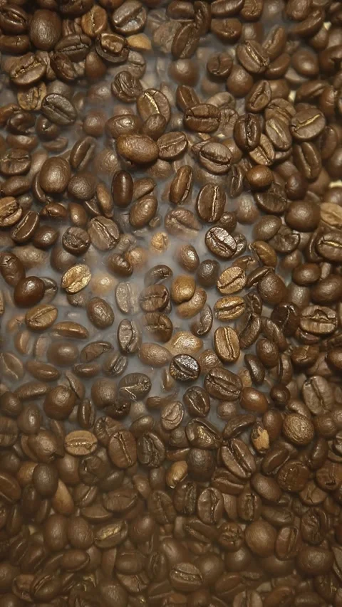 Vertical video of coffee beans smoke Stock Footage 242685296