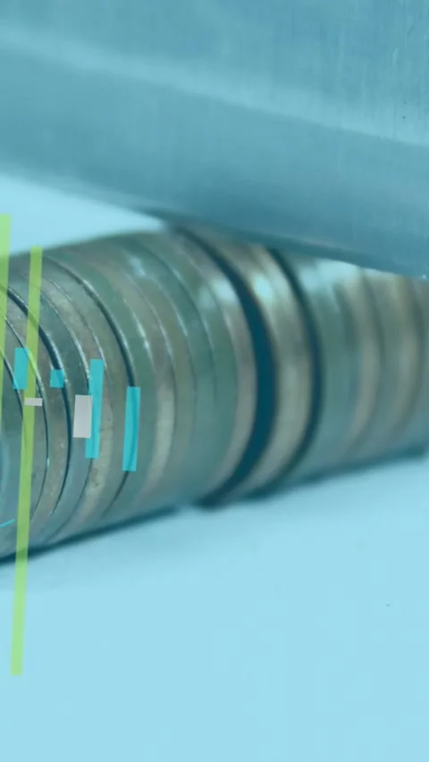 Vertical video: Coin stack sitting on desk as metal bar settling making finance Stock Footage 331738669