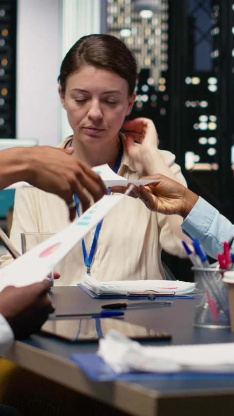 Vertical Video Collaborating, multiethnic team of office clerks completing Stock Footage 334106413
