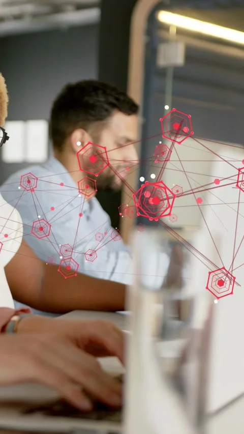 Vertical video: Colleague typing, causing red hex overlay growing over screens, Stock Footage 334046827