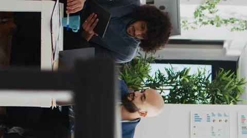 Vertical Video Colleagues comparing data analytics Stock Footage 244116027
