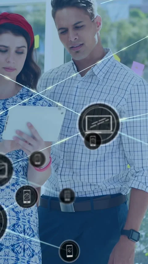 Vertical video: Colleagues tapping tablet during tech demo, expanding icons Stock Footage 329841156