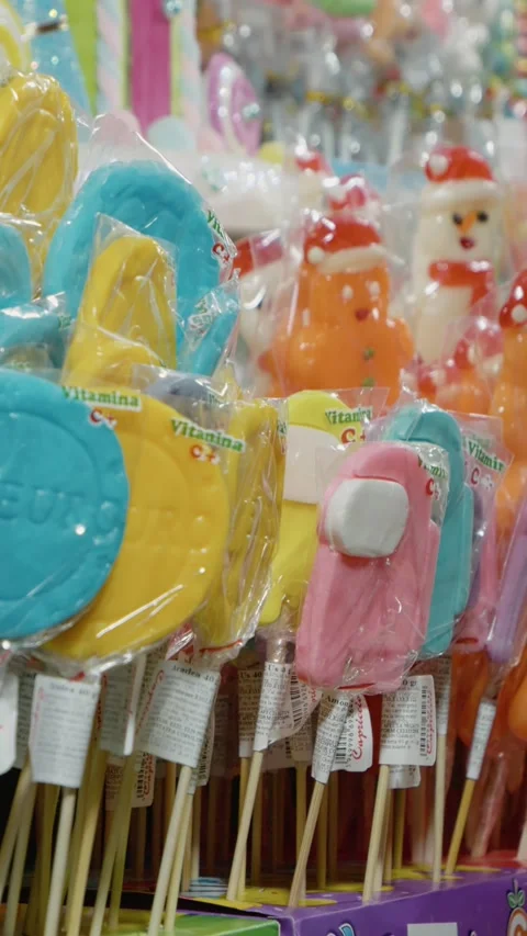 Vertical video Colorful sweets and lollipops at the festive Christmas market Stock Footage 316487589