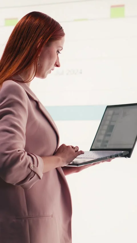 Vertical video Comparing profit data, laptop and businesswoman using charts Stock Footage 330028074