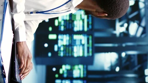 Vertical video Computer scientist fixing server issues Stock Footage 246014868