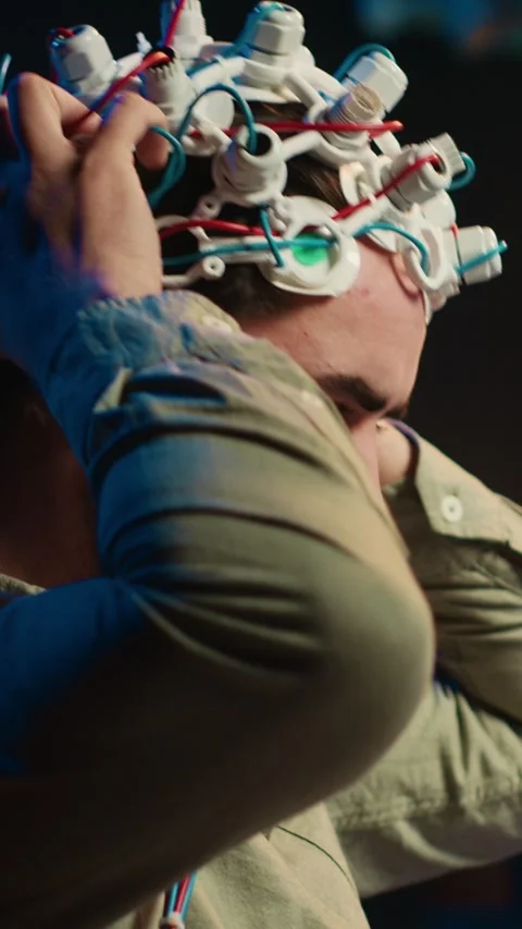 Vertical video Computer scientist puts EEG headset on, links brain to cyberspace Stock Footage 266749072