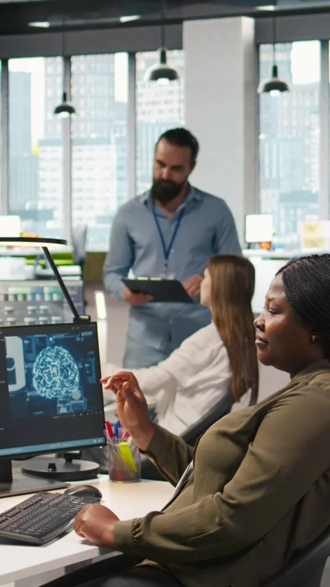 Vertical video Computer scientist in startup office reviewing AI system metrics Stock Footage 312709084