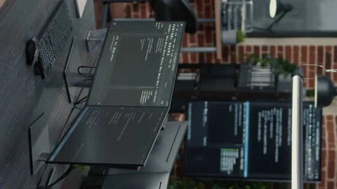 Vertical video Computer screens running programming code in empty software it Video stock 194146523