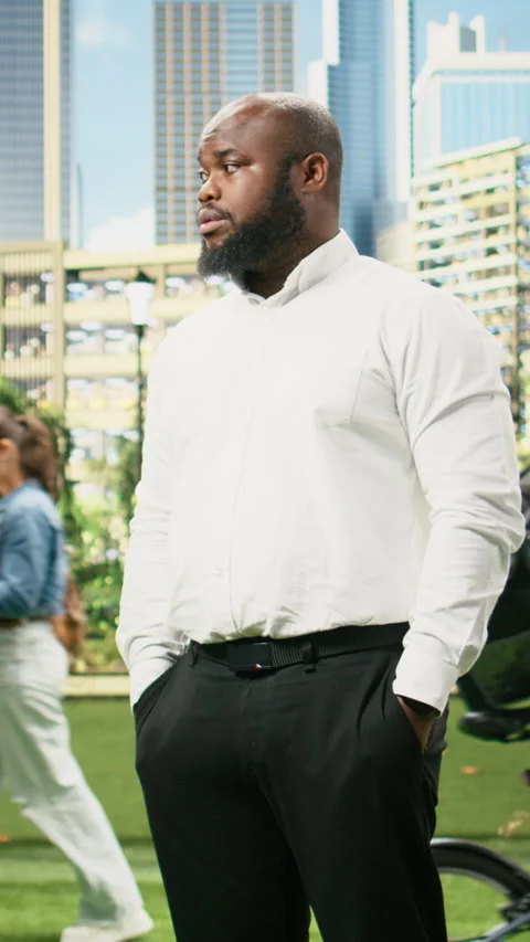Vertical Video Concerned businessman checking time on smartwatch while standing Stock Footage 344383409