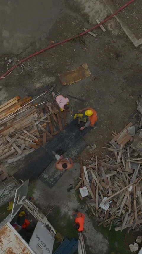 Vertical Video: Concrete foundation work underway as workers pour concrete on a Stock-Footage 297655880