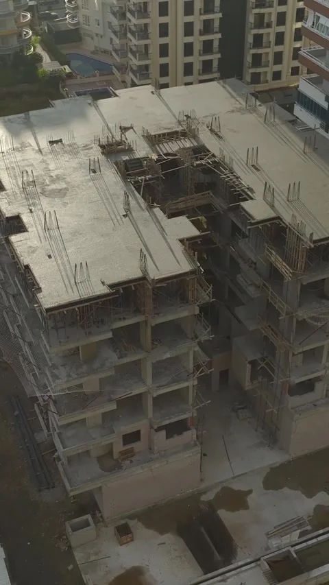 Vertical Video: Concrete pouring on a bustling construction site, laying the Stock Footage 297655812