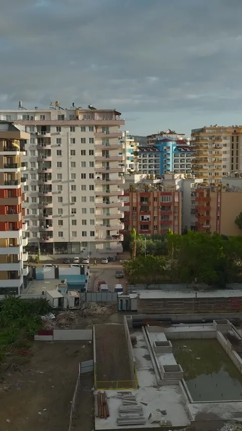 Vertical Video: Concrete pouring in progress on a busy site as workers shape the Stock Footage 297656097