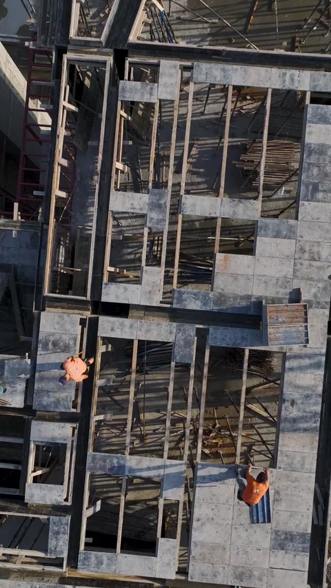 Vertical Video Concrete Structure Framework with Workers and City Background Stock Footage 342120995