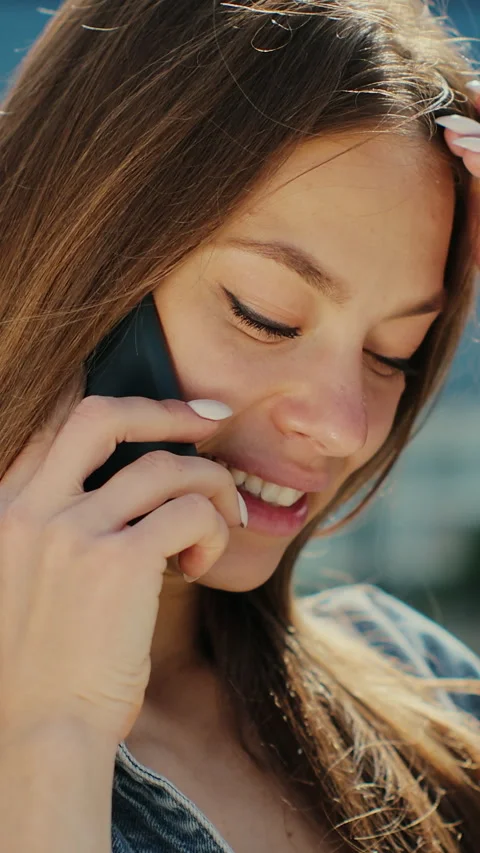 Vertical video. Confident woman talking on smartphone at street. Stock Footage 344684113
