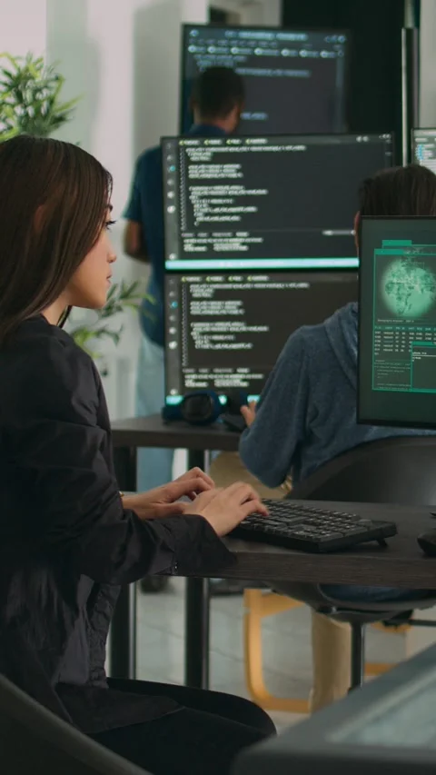 Vertical video: Confused asian engineer having it system hacked on computer Stock Footage 218577973