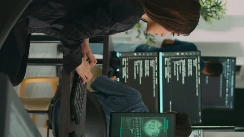 Vertical video: Confused asian engineer having it system hacked on computer Stock Footage 219702859